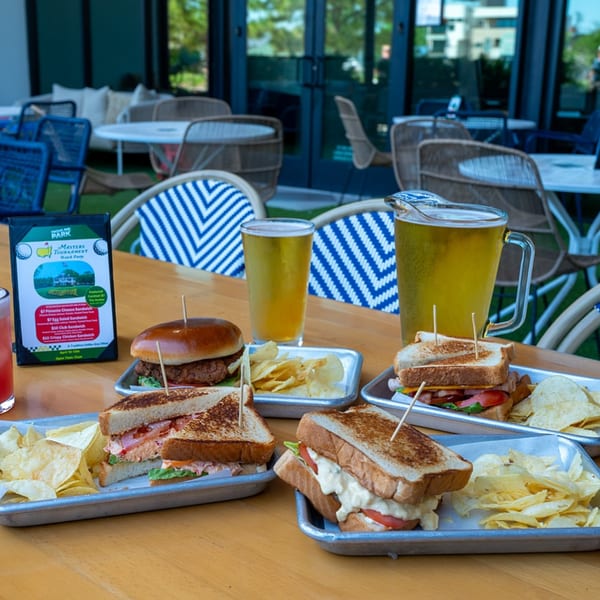Highline Park bar-&-grill outdoor patio with sandwiches, chips, beer, and a Masters Tournament menu.