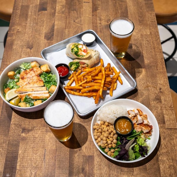 Highline Park bar-&-grill dishes: chicken Caesar salad, chicken wrap with fries, and a chicken bowl.